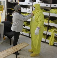 Workers with Hanford contractor Central Plateau Cleanup Company practice new protocols for putting on and removing personal protective equipment