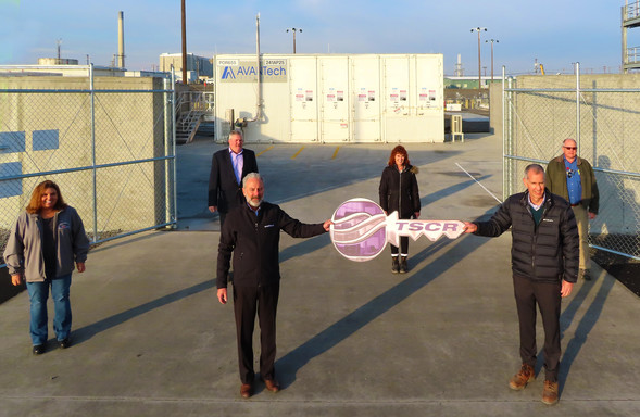 Hanford leadership is handed a symbolic key from WRPS to indicate construction and readiness assessments are complete on TRSCR.