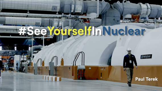 A man walking by a turbine