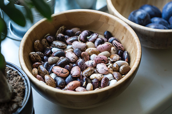 Photo of a variety of dried beans in a bowl on a table