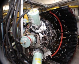 Photo of the FRIB Decay Station initiator, a machine with large cylinders coming out of it and wires