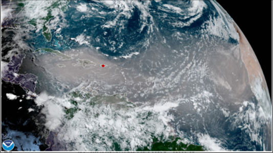 Satellite image of the Earth with a plume of smoke / dust across the Pacific Ocean with a red dot over Puerto Rico