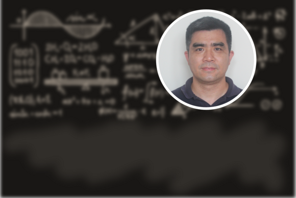 Photo of Junjie Zhu (an East Asian man) against a background that looks like a chalkboard with blurred equations