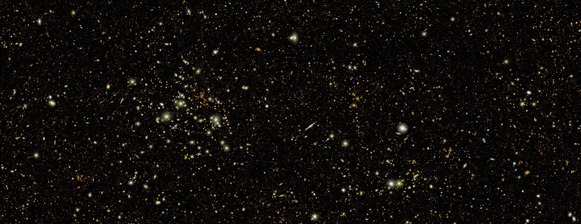 A simulated image with hundreds of thousands of galaxies that look like pinpricks or smudges of bright white light and a few yellow