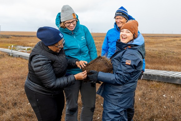 SC Director Berhe and Arctic Office Director Erin Whitney with scientists holding a soil sample on the Alaskan tundra