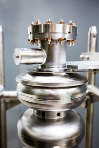 Niobium superconducting cavity of an accelerator, which has two silver donut-shaped compartment 