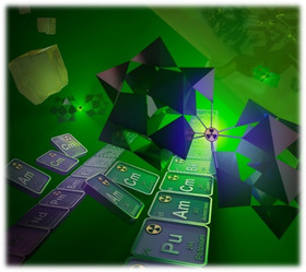 Illustration of a section of the Periodic Table overlaid with the radioactivity symbol and polygons