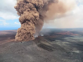 Smoke billowing from black volcanic rock from the 2018 Kīlauea volcano eruption