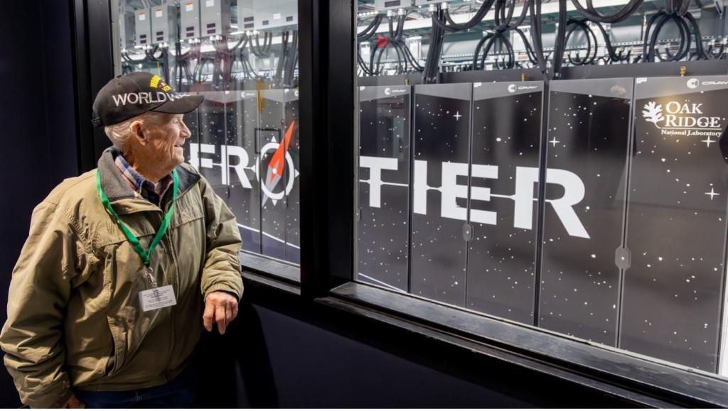 Ross Blevins looking through a window at the cabinets for the Frontier supercomputer