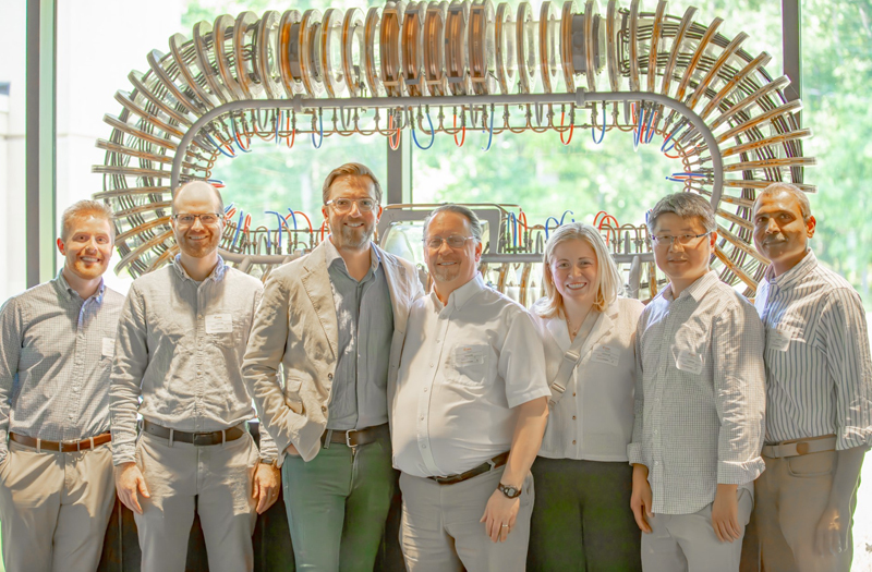 The Thea Energy team in front of the PPPL model stellarator 