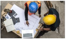 People wear hard hats and review plans 