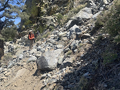 Hiker by a rockslide on the Pacific Crest Trail