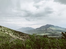 Photograph of mountains with cloudy skies