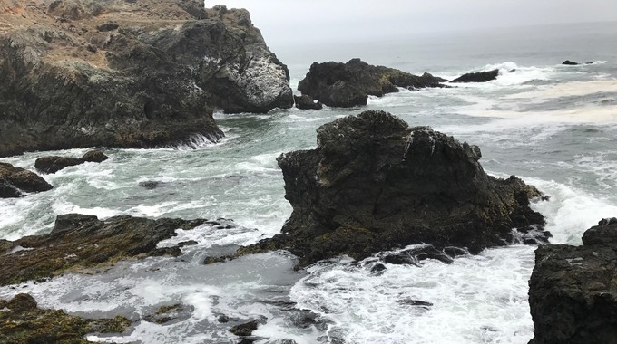 Waves crashing on rocks in the California coast