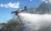 A plane drops water on a wildfire in Everglades National Park.