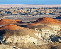 desert landscape with orange colored rock mounds. 