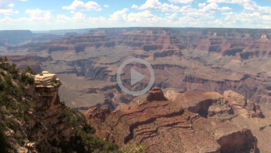 A view of the Grand Canyon, a landscape of massive red rock canyons and cliffs.