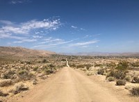 A dirt road in a desert.