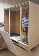 Woman standing in a partially constructed display case
