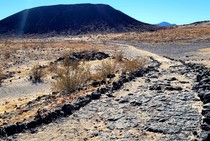 A rocky trail leading to a crater.