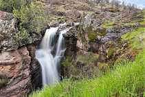 A waterfall flowing over a rock ledge.