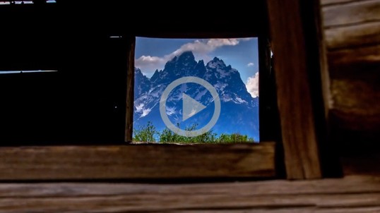 View of mountains through a cabin window