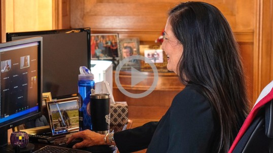 Secretary Haaland sits at her desk on a video conference call