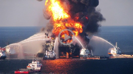 An oil rig on fire in the ocean