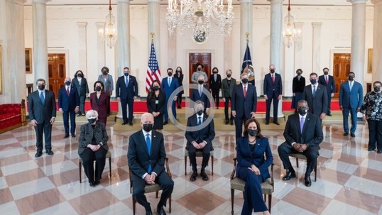 The president and a his cabinet sit in chairs