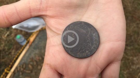 A person hold an old coin