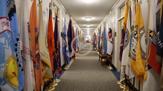 Tribal flags lined up down a hallway