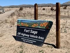 A new Fort Sage road sign leaning against a beam.