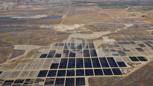 A huge area of solar panels is seen from the view of a plane