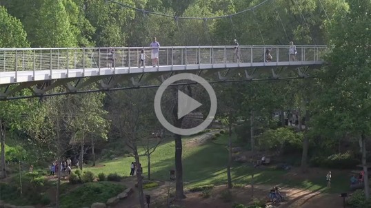 A bridge through a park in an urban area 