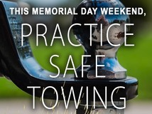 A photo of a trailer hitch and sparks with the words: This memorial day weekend, practice safe towing. 
