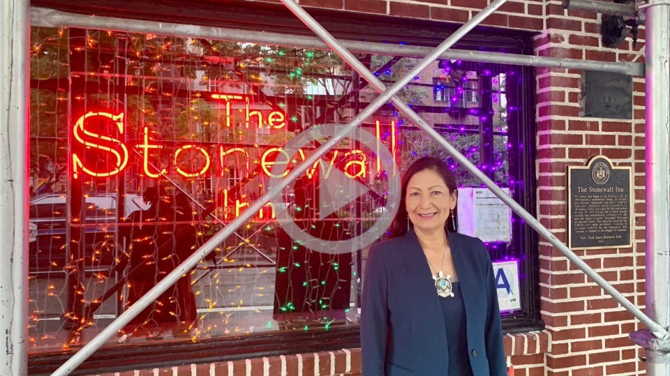Secretary stands in front of the Stonewall Inn