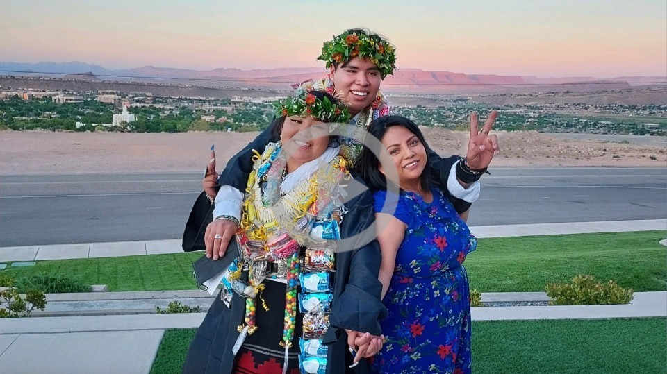 Three tribal graduates pose for a graduation photo