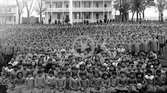 An old black and white photo of an Indian boarding school