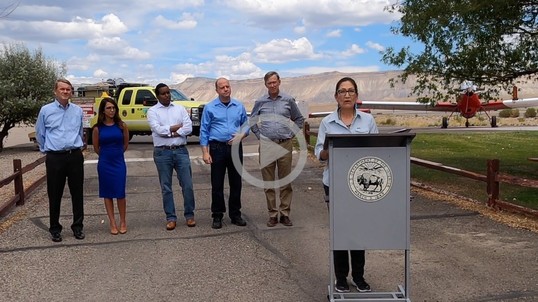 Secretary Haaland stands at a podium and delivers remarks in Colorado