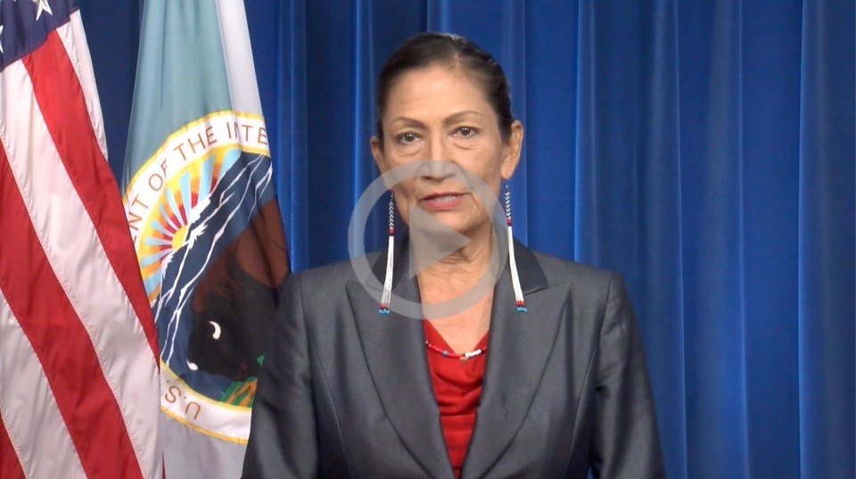 Secretary Deb Haaland stands to give a speech about Women's Equality Day