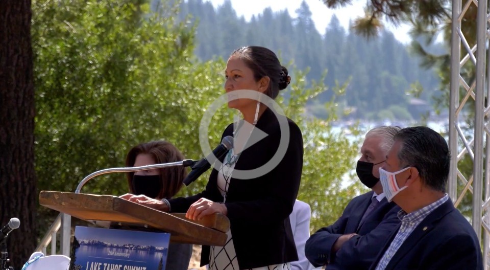 Secretary Haaland stands at a podium to deliver a speech at Lake Tahoe