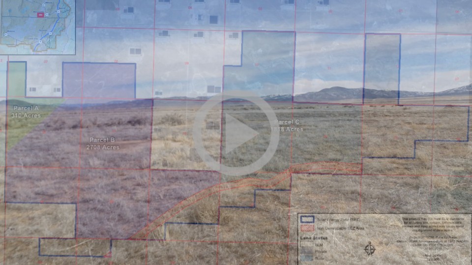 A map is overlaid across a dry looking desert area