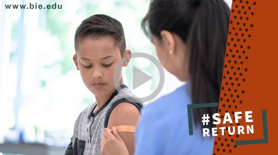 A child with a rolled up sleeve gets a shot from a medial professional