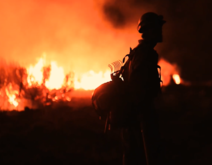 Silhouette of a firefighter against flames.