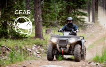 A four-wheeler driving on a dirt road.