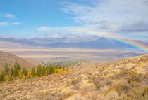 A rainbow over a mountain valley.