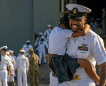 A man in uniform holding a child.