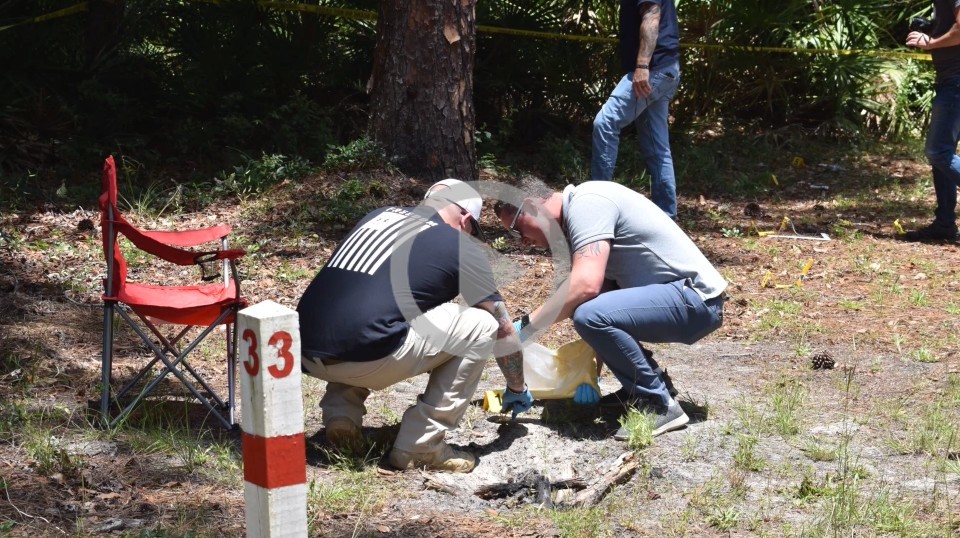 Two people conduct tests in the ground