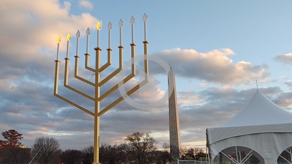 A menorah is set up at the Washington DC Mall area with the Washington Monument in the background 