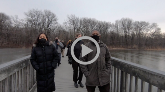 Secretary Haaland and community members walk across bridge at John Heinz National Wildlife Refuge